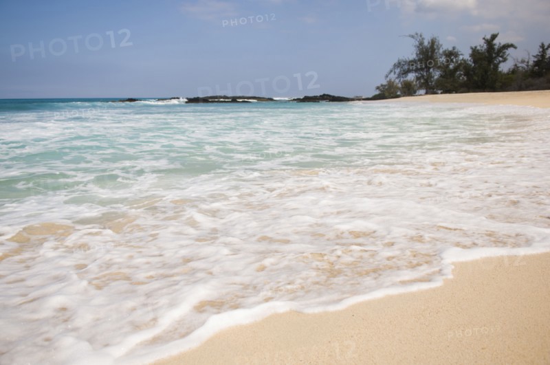 Waves washing up on tropical beach
