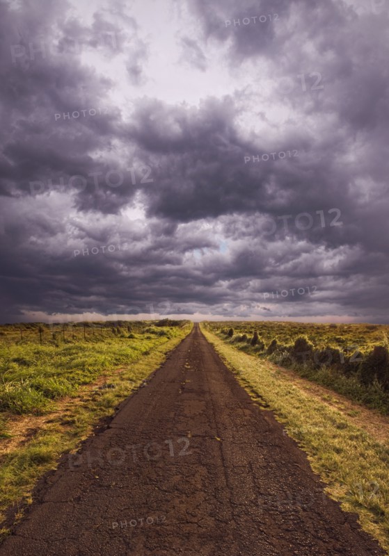 Rural road under cloudy sky