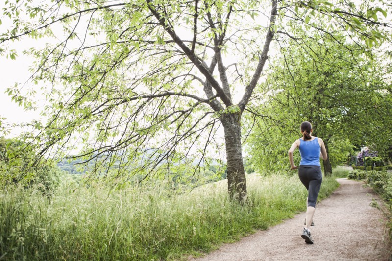 Mixed race woman running on path