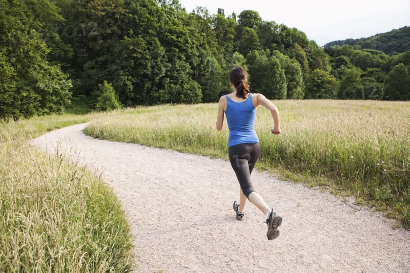 Mixed race woman running on path