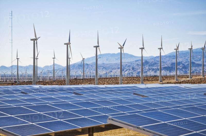 Wind turbines and solar panels in remote landscape