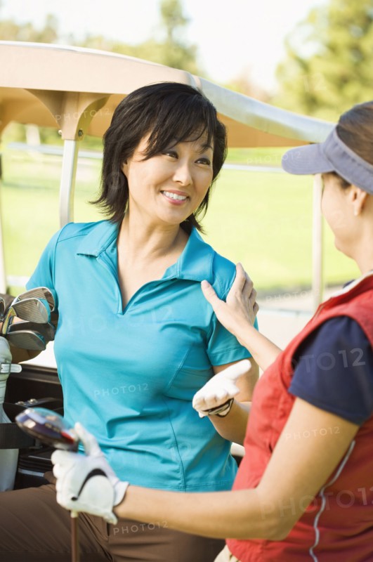 Women talking on golf course