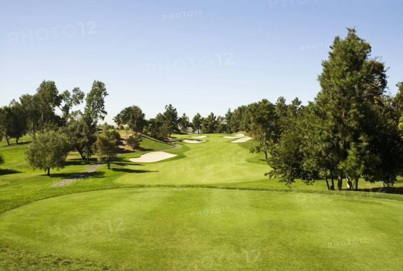 High angle view of golf course under blue sky
