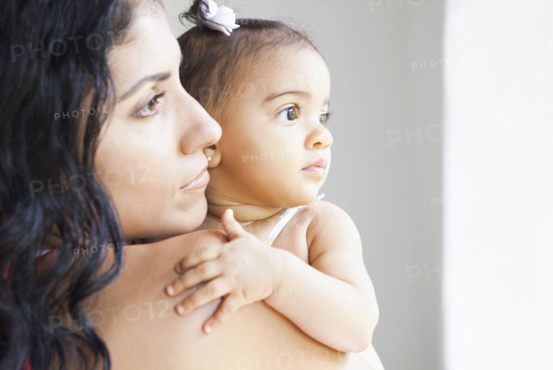Mixed Race mother holding baby daughter