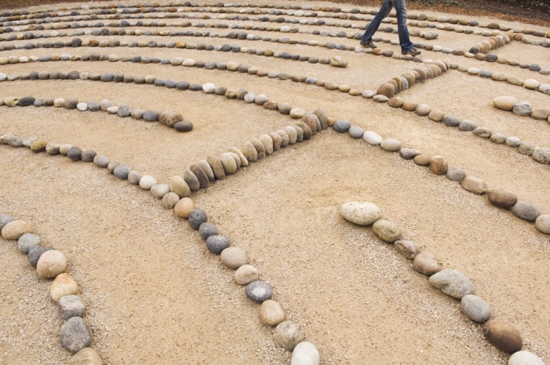 legs of Mixed Race woman walking in maze