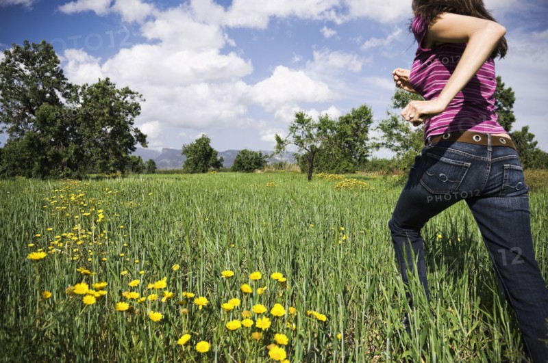 Mixed Race woman running in field