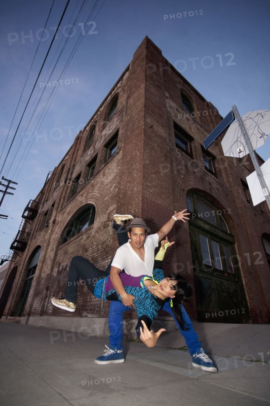 Couple breakdancing in urban area