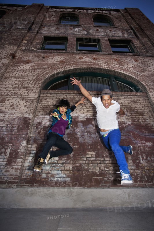 Couple breakdancing in urban area
