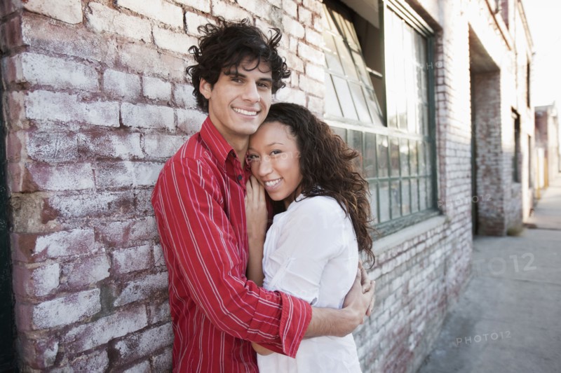 Couple hugging in urban area