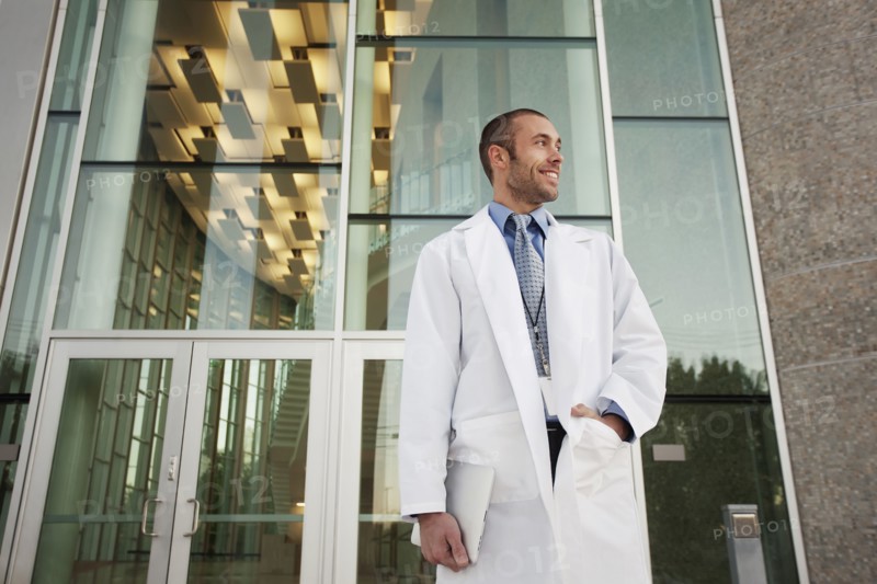 Doctor holding digital tablet outdoors