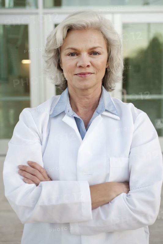 Smiling doctor standing outdoors