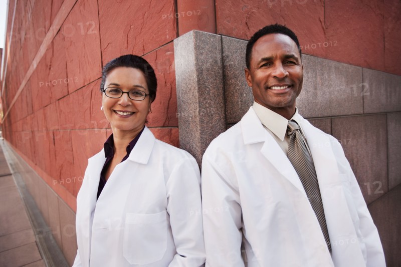 Smiling doctors standing outdoors