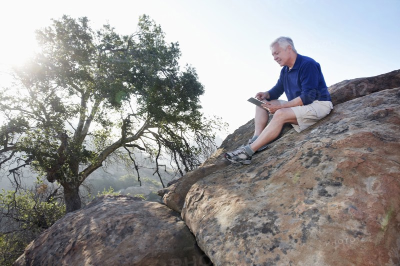 Caucasian man using digital tablet in remote area
