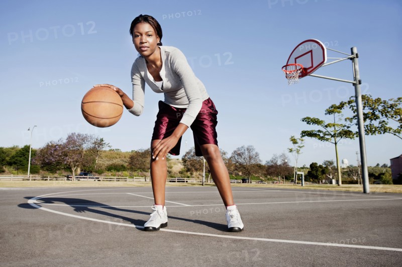 Young woman playing basketball