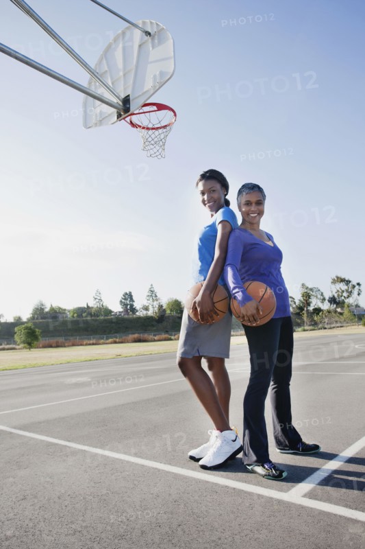 Mother and daughter playing basketball