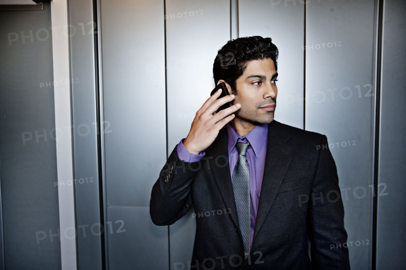 Hispanic businessman talking on cell phone