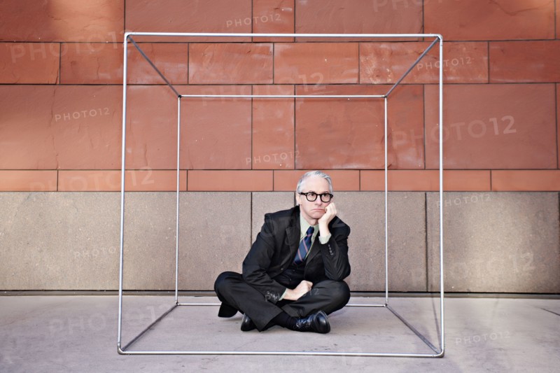 Caucasian businessman sitting inside of box