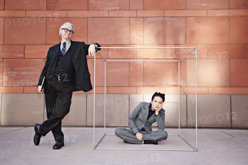 Businessman standing next to co-worker in box