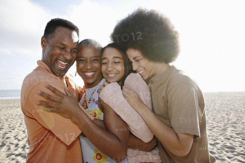 Family hugging on beach