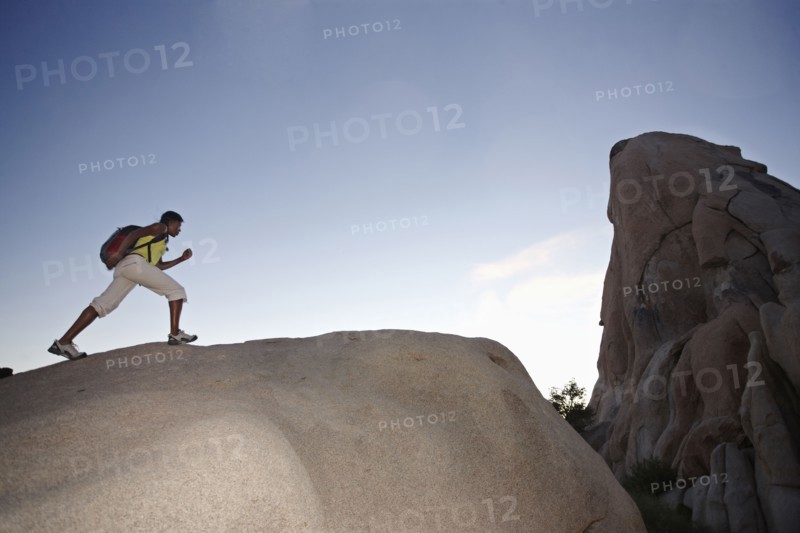 Woman hiking on large rock
