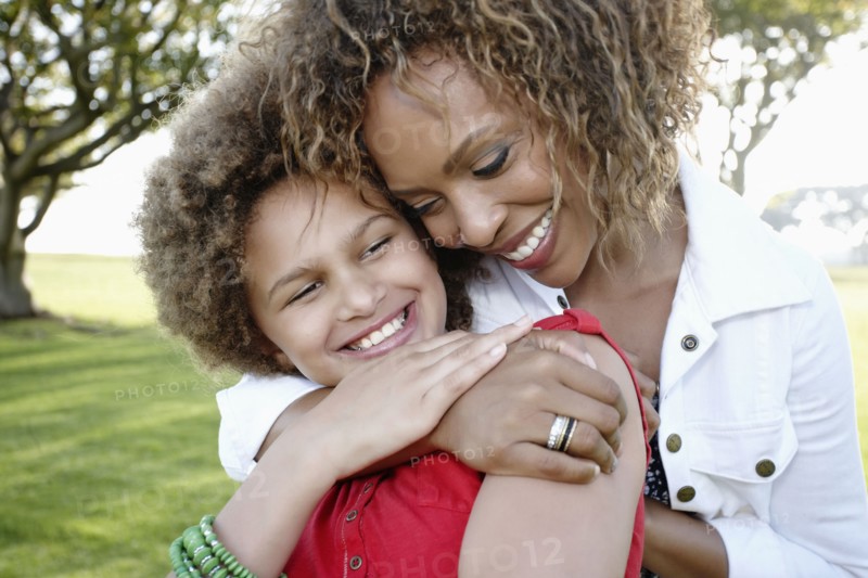African American mother and daughter hugging