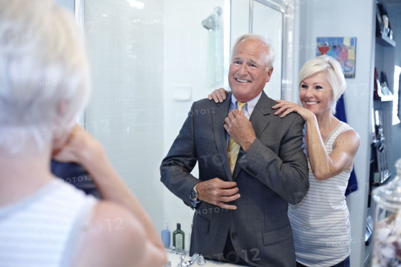 Caucasian couple dressing in bathroom