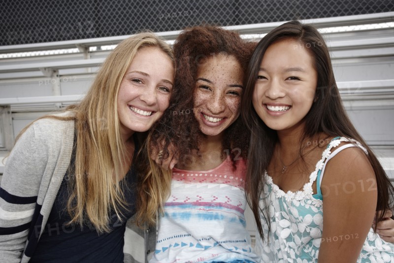 School friends sitting together on bleachers