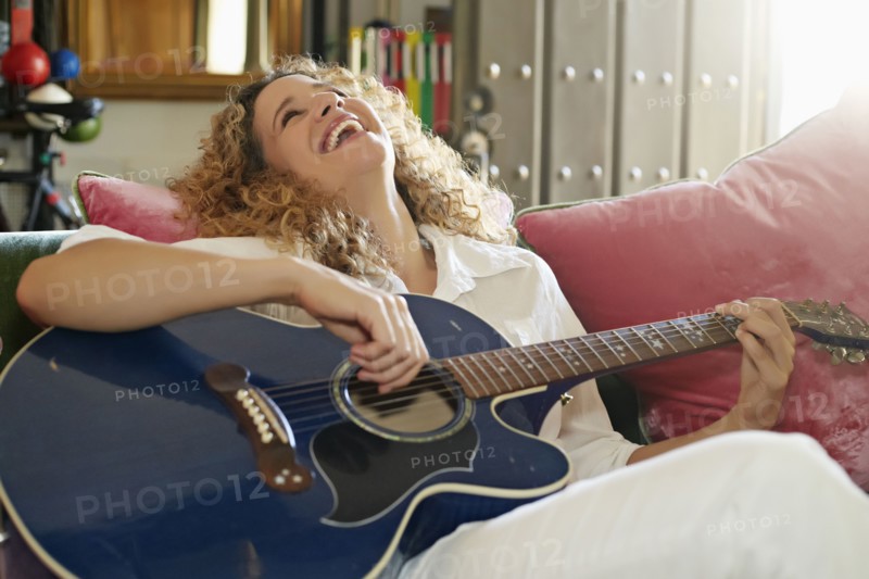 Caucasian woman playing guitar