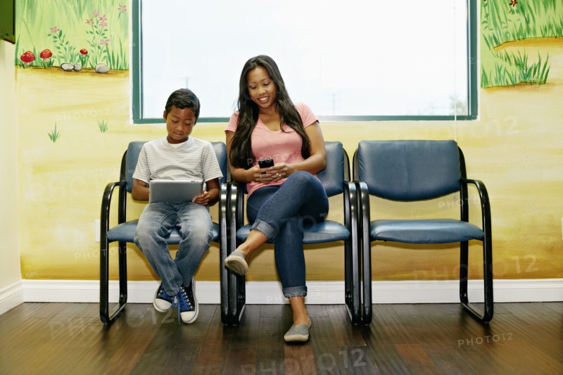 Mixed race boy and mother in waiting room
