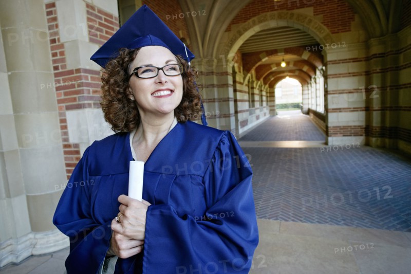 Smiling Caucasian woman holding graduation diploma