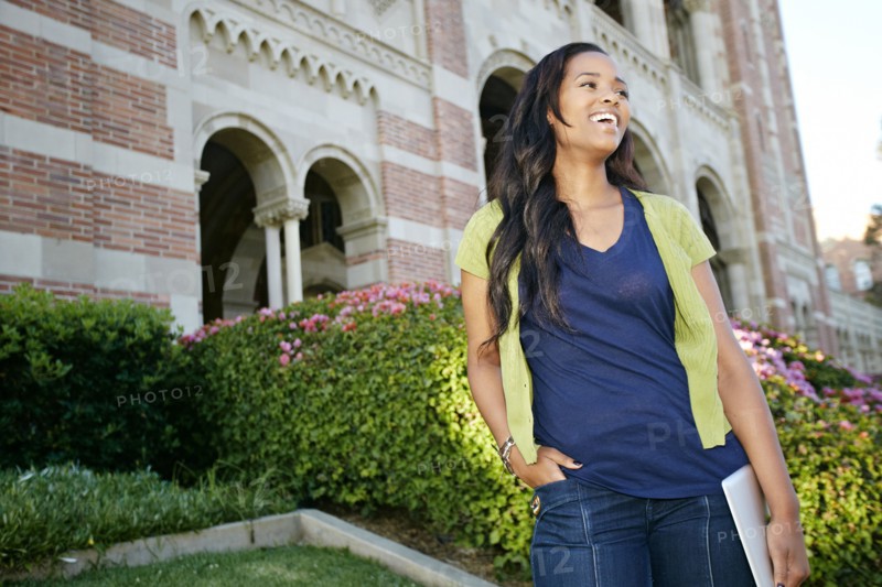 Mixed race college student holding digital tablet