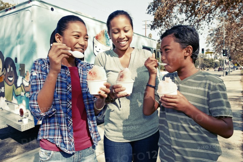 Family eating ice cream from truck