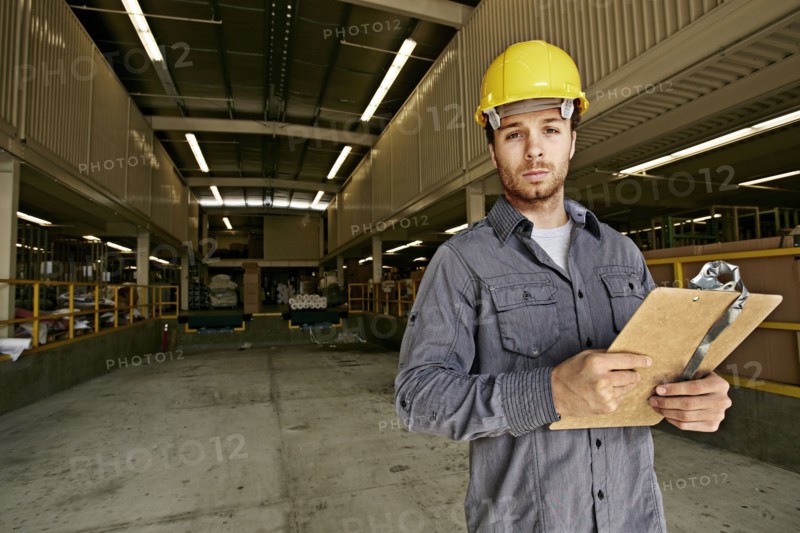 Caucasian worker with clipboard in warehouse