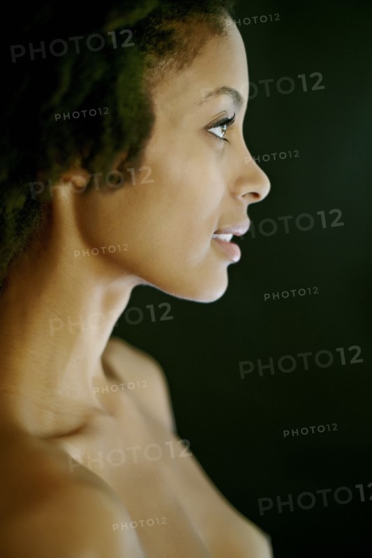 Nude mixed race woman smiling