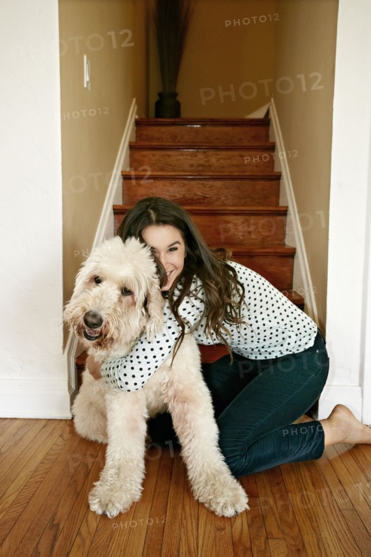 Caucasian woman hugging dog by steps