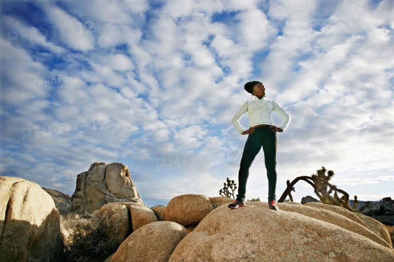 Black runner in desert landscape