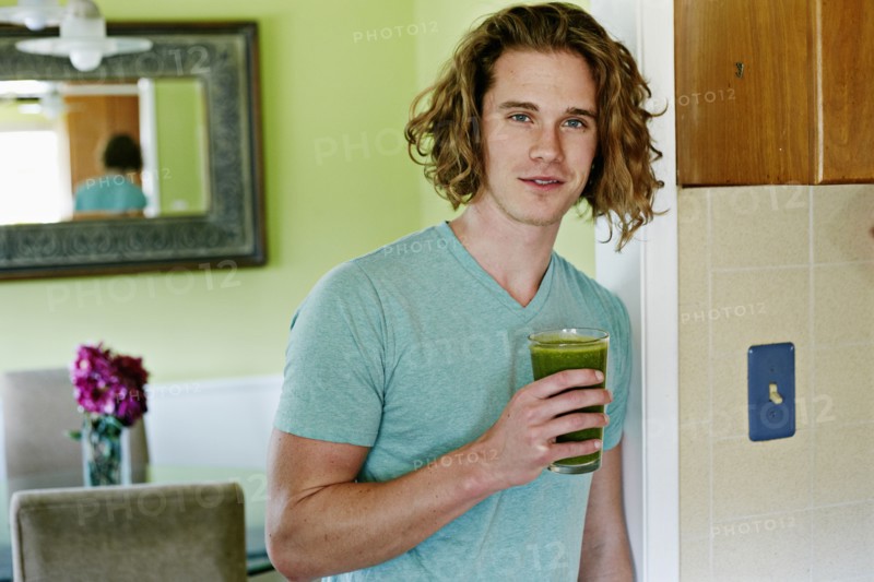 Caucasian man having glass of juice