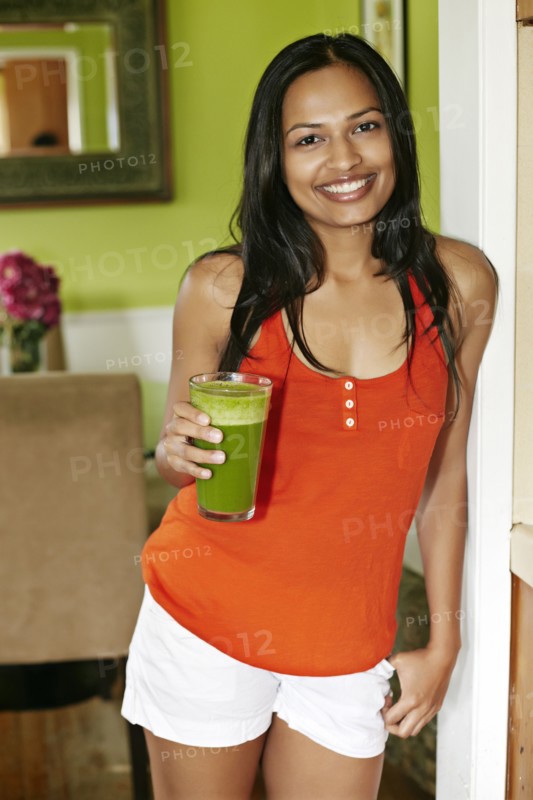 Indian woman having glass of juice