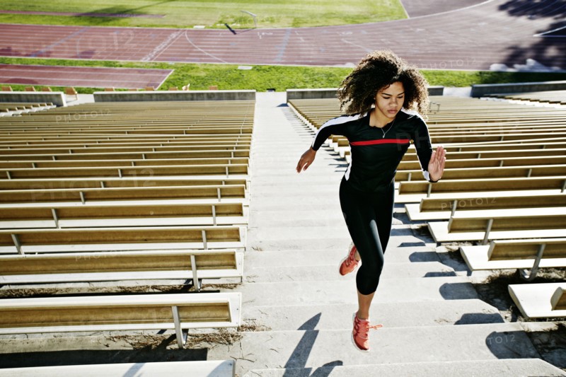 Mixed race runner training in stadium
