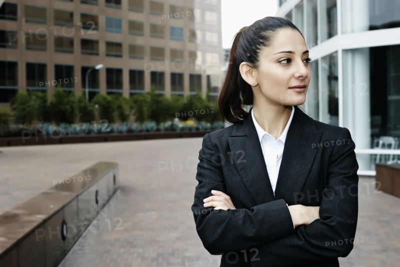 Mixed race businesswoman standing outdoors