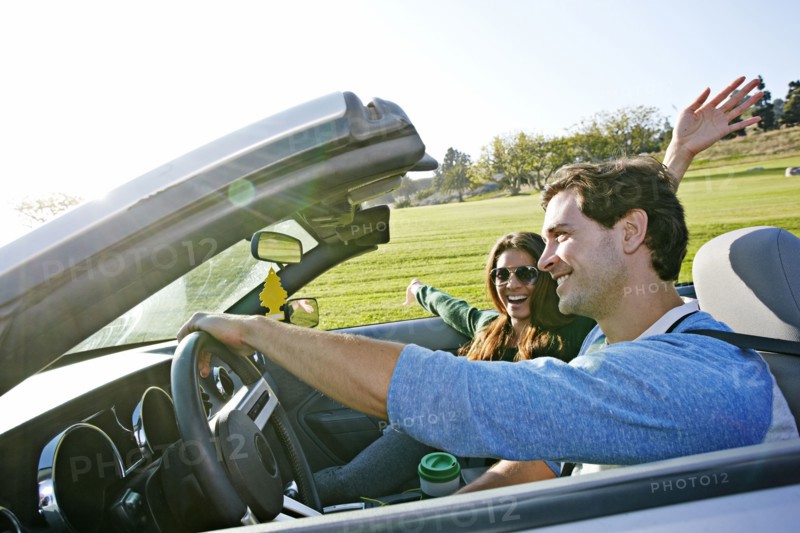 Couple driving in convertible