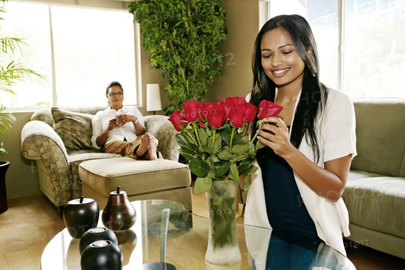 Woman arranging flowers in vase
