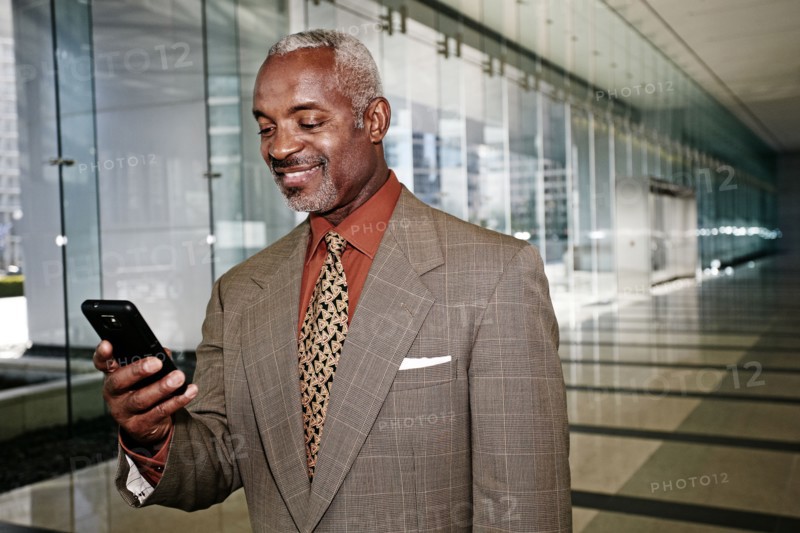 Black businessman using cell phone