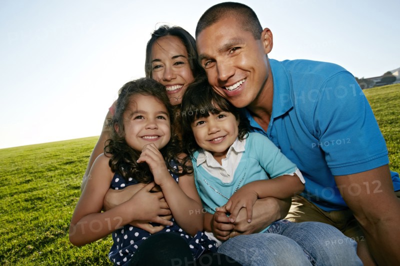 Family smiling together in field