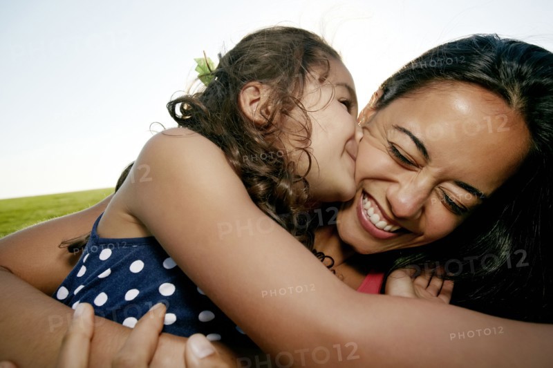 Girl kissing mother on cheek