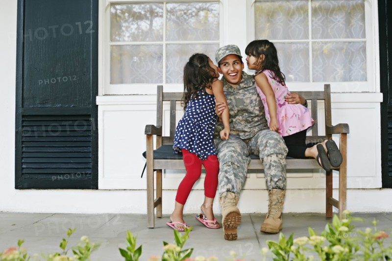 Soldier mother with daughters on patio