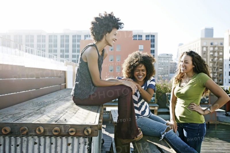 Women relaxing on urban rooftop