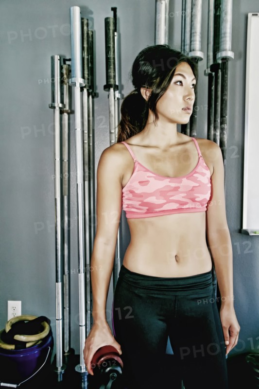 Asian woman working out in gym