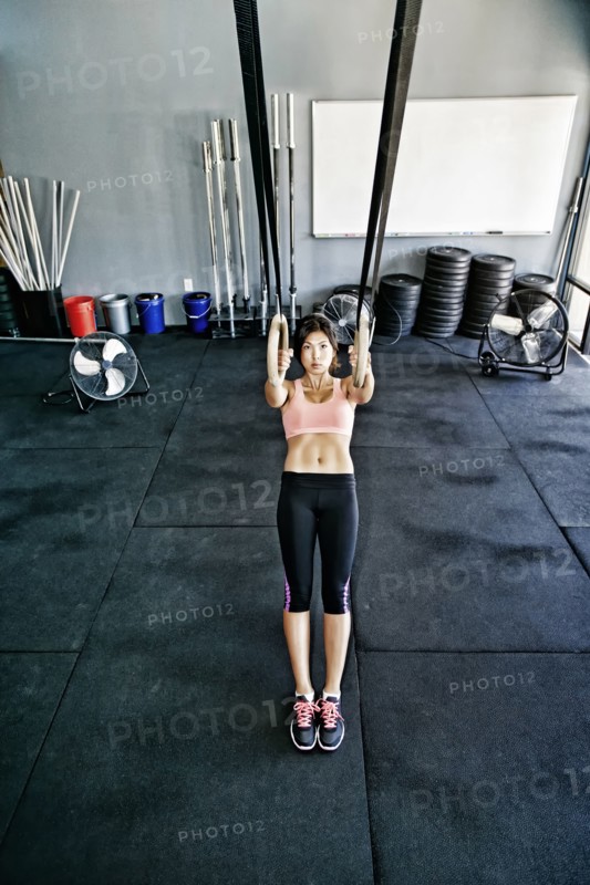 Asian woman working out in gym