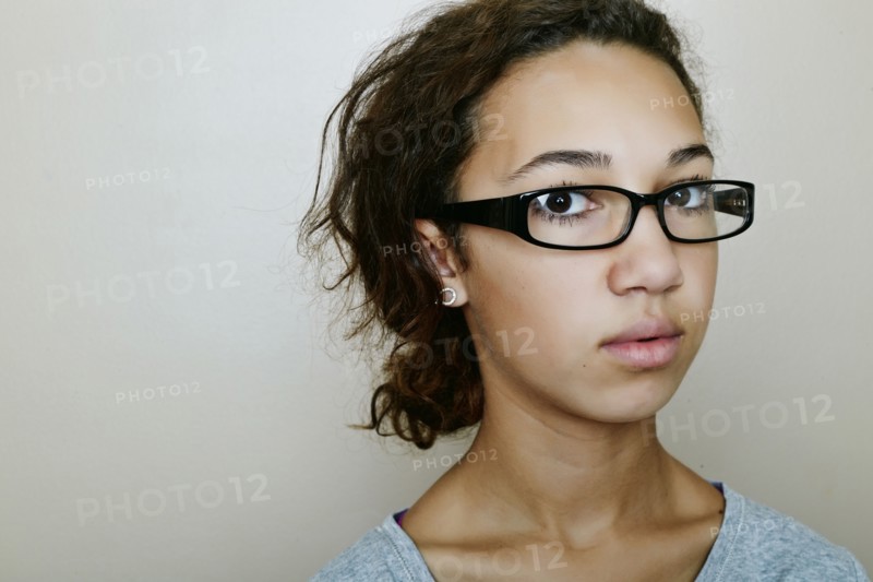 Mixed race teenage girl wearing eyeglasses